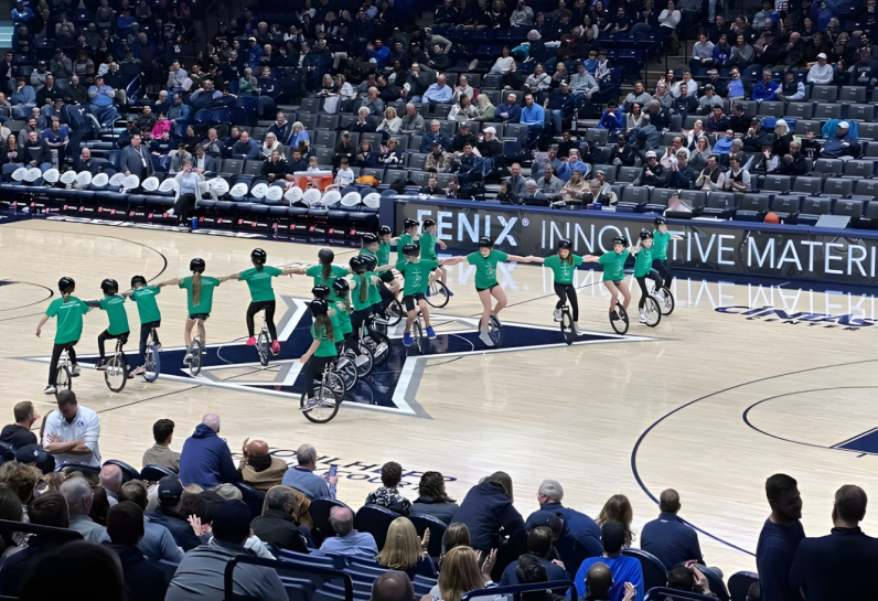 kids unicycling on basketball court